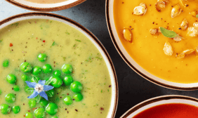 a variety of vegan soups in bowls with a variety of toppings