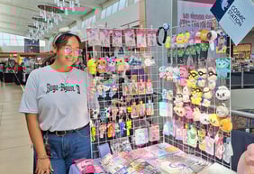 a woman standing in front of a display of toys