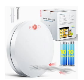 a white smoke detector with a battery and batteries