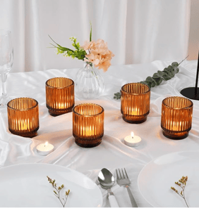 a table with candles and photophores on it