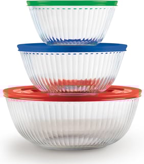 a stack of three pyrex bowls with plastic lids