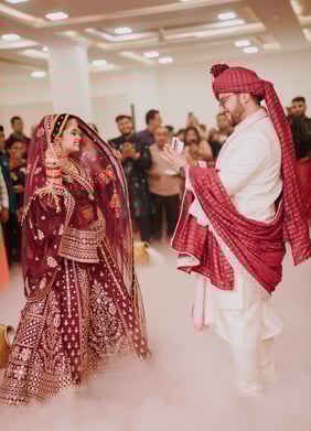 a man and woman in traditional indian wedding attire