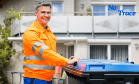 a man in a safety vest holding a blue bin