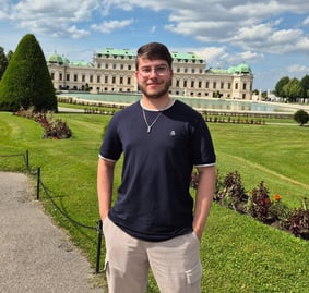 a man standing in front of a large building