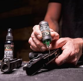 Mossy Oak Gun Oil being applied to a pistol