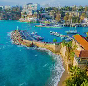 a view of a beach with boats and buildings
