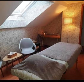 a bedroom with a bed and a chair