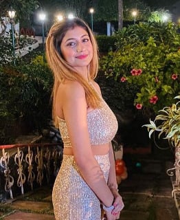 Preeti petite teen look escort in Gurgaon smiling playfully