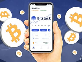 a person holding a phone with bitcoin on it
