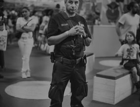a man in a police uniform is holding a camera