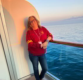 Shelly on a balcony of a Carnival Cruise to Alaska 