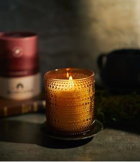 a fall scented candle in a glass candle holder