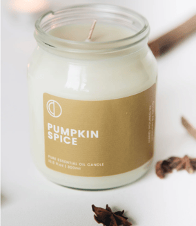 a pumpkin spice candle that is sitting on a table