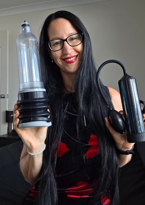 Pleasurelit Patricia holding two different penis pumps for tips