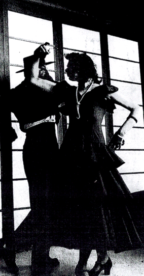 a woman in a black dress and a man in a suit dancing flamingo