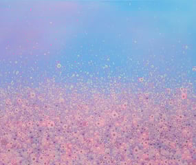 a pink and blue sky with lots of bubbles in the air