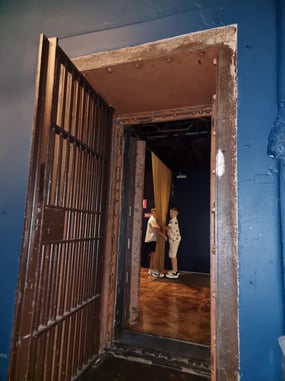 Photo inside the Vault function room looking out into the waiting room with children playing with hanging chains.