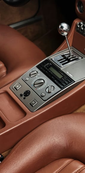 a car dashboard with a clock and a clock on the dashboard