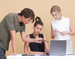 A person using a laptop or tablet, likely planning a trip. The screen might show a map, flight optio