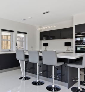 Modern bespoke kitchen with black cabinetry and large central island in East Kilbride.