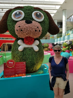 Lady poses with some local plant art at the mall at Pan Pacific Hotel in Singapore