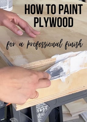 a person painting a wood table with a paintbrush