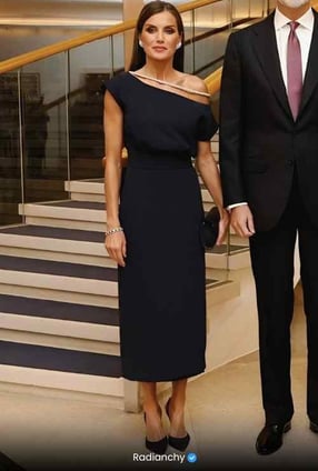 a man and woman standing in front of stairs