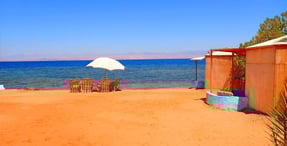 Bedouin star beach with chairs and umbrellas on the sand