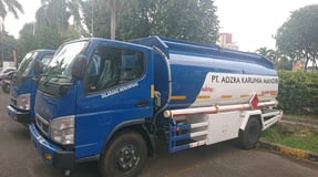 a blue truck with a white tank on it