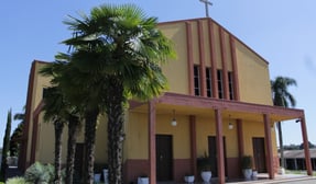 a church with a cross on the side of the road
