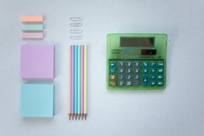 a calculator with a calculator and pencils