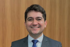 a man in a suit and tie smiling
