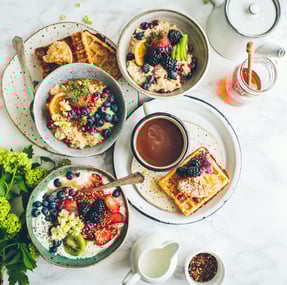 a table with plates of food and a cup of coffee