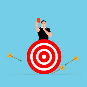 a man holding a phone while standing on a target