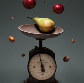 a pear on a scale scale scale with apples and nuts