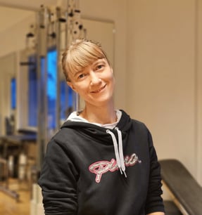 a woman in a black hoodie and a black and white hoodie