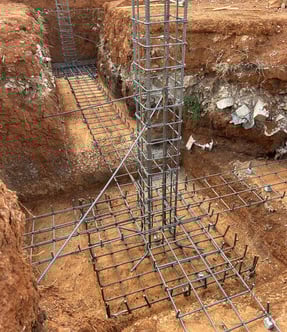 a construction worker is working on a steel structure