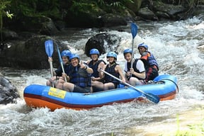 Family enjoying kid-friendly rafting adventure on Ayung River, Ubud, Bali