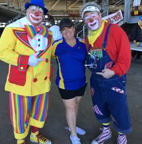 Deanna the Inspector standing next to 2 clowns