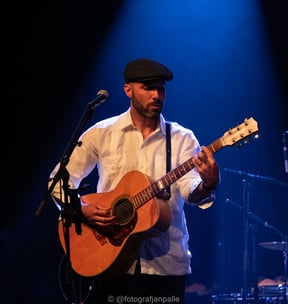 a man with a hat and a guitar