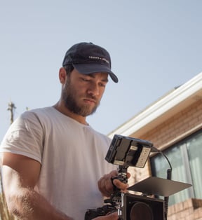 a man in a white shirt and a camera