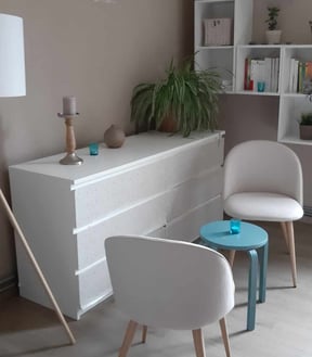 a living room with a white chair and a table