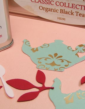 die cut paper teapot in teal with damask decorations in silver foil