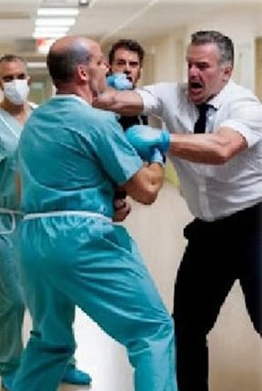 a doctor wearing a scrub attaccked by a patient in the hospital