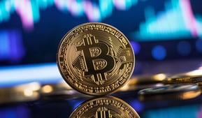 bitcoin on black surface with charts in background