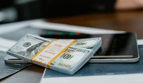 bunch of money and investing charts and graphs