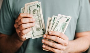 cash in someones hand for augusta precious metals fees