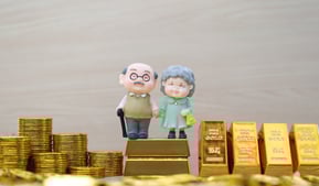 elderly couple with gold bars and coins for retirement
