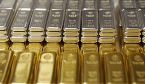 gold and silver bullion bars in rows and stacks