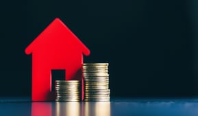 house with coins on side for real estate investing
